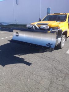 A yellow truck with a Fisher straight plow attached.